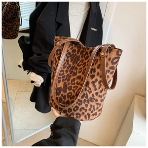 Detail of leopard print suede tote with leather handles and metal rivets