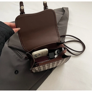 Internal view of a small retro backpack showing the zipper pocket and daily essentials