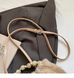 Detailed view of adjustable PU leather strap and decorative marble beads on plush bag