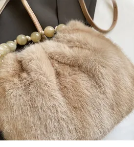 Close-up of faux mink fur leopard bucket bag with large translucent bead handle detail