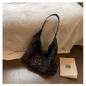 Detail of vintage leopard print hobo bag showing soft knit texture and leather strap