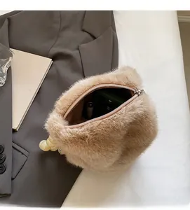 Top view of faux mink bucket bag showing interior space with phone and lipstick