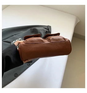 Detailed macro of vintage caramel brown leather texture and two functional front pockets