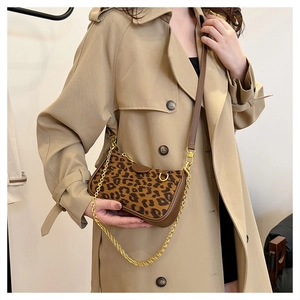 Detail view of retro leopard print handbag with golden metal chain and shoulder strap