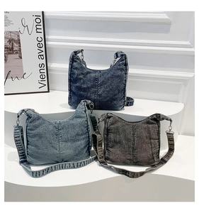 Detailed display of three denim crossbody bags in dark blue, light blue, and charcoal grey