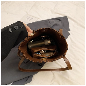 Top down view of leopard print bucket bag interior showing spacious storage and magnetic clasp