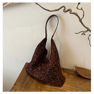 Detail of red-brown leopard print tote bag with soft texture and suede-like finish