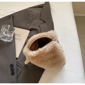 Close-up of soft faux mink fur bucket bag with pearl handle and metal zipper detail