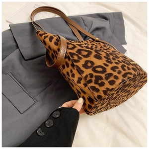 Detail of leopard print faux suede texture and leather handle on the bucket bag