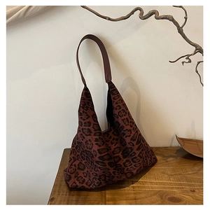 Detailed view of the leopard print tote bag with soft fabric and brown leather strap