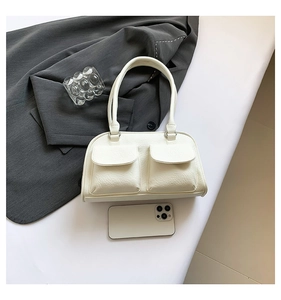 Detail of white PU leather shoulder bag with dual front flap pockets and phone size reference