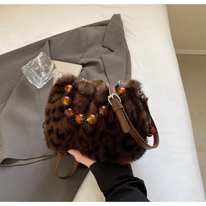 Close-up of leopard faux fur bucket bag with amber resin beads and leather strap