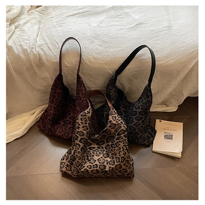 Detailed trio of vintage leopard print tote bags in burgundy, grey, and brown fabric