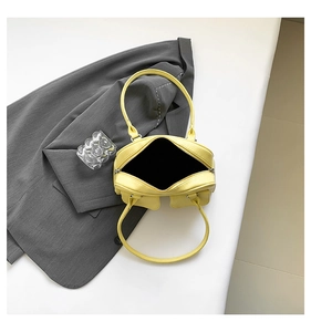 Internal view of pale yellow textured PU leather shoulder bag with zipper closure