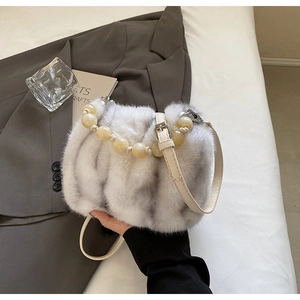 Detail of faux mink bucket bag with resin beaded handle and soft plush texture