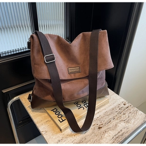 Close-up of coffee brown tote bag featuring mixed textures and adjustable fabric strap