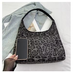 Leopard print tote bag size comparison with a smartphone on casual denim background