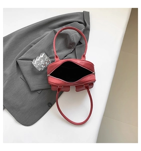 Deep red leather bag interior view with top zipper and inner pocket detail