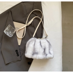 Close-up of faux mink fur handbag featuring elegant pearl clasp and thin leather strap