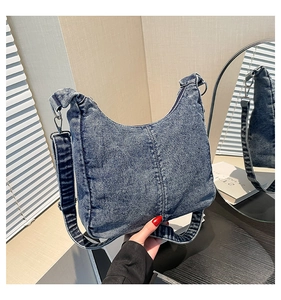 Close-up of the washed denim texture and sturdy metal hardware of the retro shoulder bag