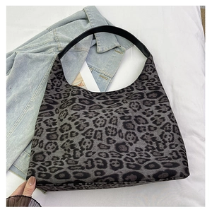 Detail of leopard print tote bag showing the soft texture and black leather shoulder strap
