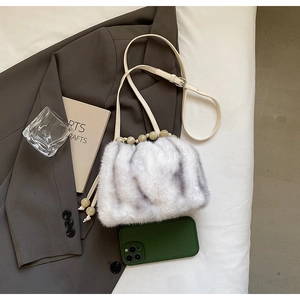 Detail of faux fur bucket bag with animal pattern, pearl bead handle and long strap