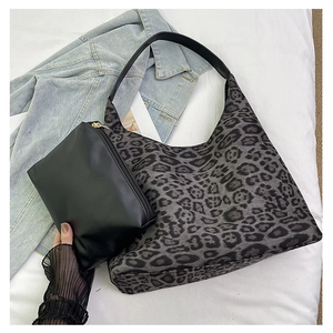 Detail view of leopard print hobo tote bag and small black zipper pouch set