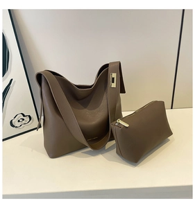 Detail view of brown hobo bag and matching pouch with premium lychee grain texture