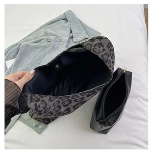 Detailed interior of leopard print tote bag showing magnetic closure and black small pouch