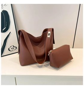 Detail view of large caramel brown tote bag and matching small pouch with metal buckle