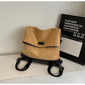 Detail of khaki suede tote bag featuring black leather trim and MARCWARE brand label
