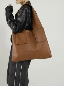 Brown large-capacity tote bag with unique circular embossed design and wide shoulder strap