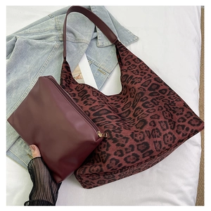 Close-up of leopard print tote bag with matching wine red zipper clutch purse set