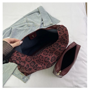 Detail view of leopard print tote bag interior with inner wine red leather pouch