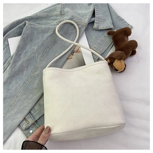 Close-up of premium white faux suede texture and seamless edge on minimalist bucket bag