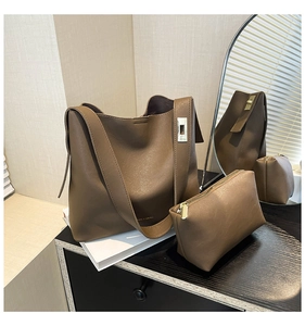 Detail view of coffee brown leather tote with silver clasp and matching inner zipper pouch