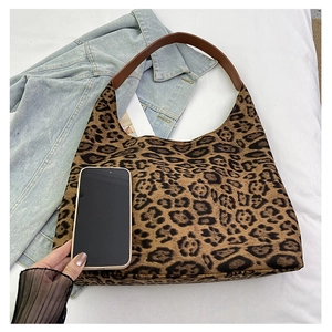 Detail view of large leopard print hobo bag showing spacious interior with a smartphone