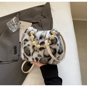 Macro detail of leopard print faux mink fur bucket bag with beaded handle and strap