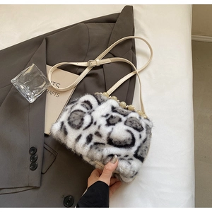 Detailed view of the leopard faux fur bucket bag with pearl handle on grey blazer