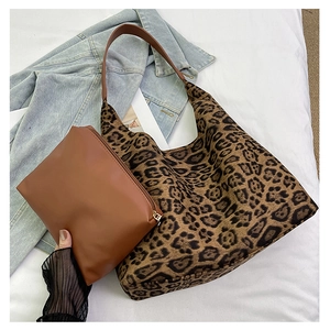 Detail of vintage leopard print tote bag with a small brown zipper pouch and straps