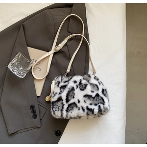 Detail of faux mink leopard print bucket bag with drawstring and adjustable leather strap