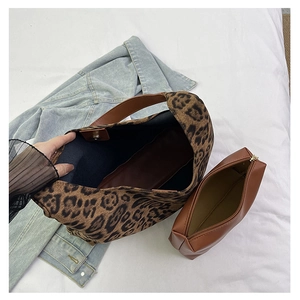 Top view of large leopard print tote bag interior with matching brown leather zip pouch