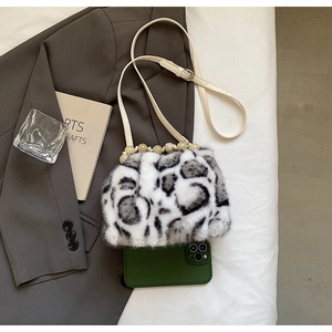 Detailed view of leopard faux fur bucket bag with pearl beads and beige strap