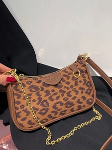 Leopard print baguette bag with brown leather trim and golden chain strap detail