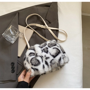 Macro view of plush leopard print faux fur texture and adjustable beige leather strap