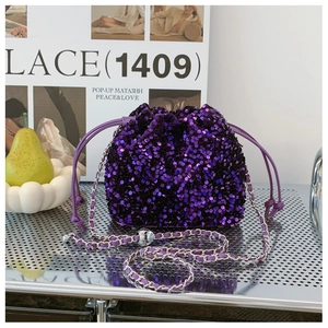 Dettaglio macro della borsa a secchiello con paillettes viola e tracolla a catena