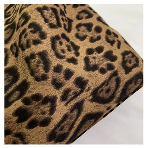Close-up of vintage leopard print tote bag fabric with soft suede texture details