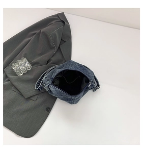Internal view showing denim texture and lining of the vintage blue shoulder bag