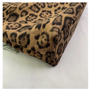 Detailed close-up showing the leopard print fabric texture and reinforced corner stitching
