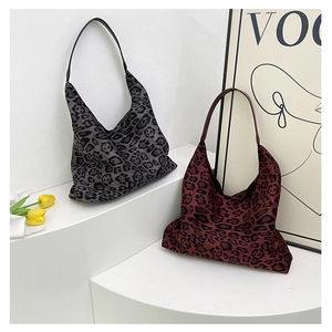 Detailed view of leopard print hobo bags in grey and dark red with minimal stitching